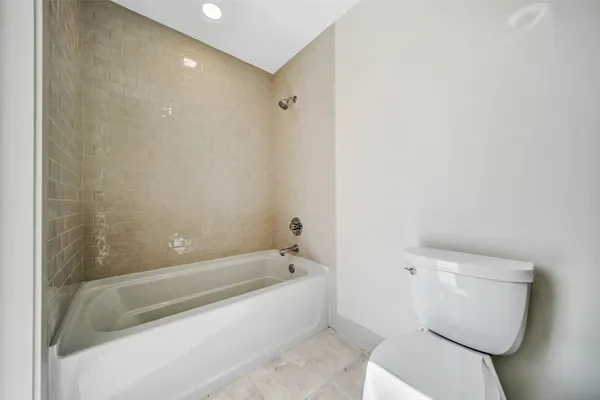 a bathroom with a toilet a sink a mirror and vanity