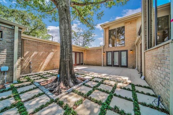 a view of a house with a tree in the background