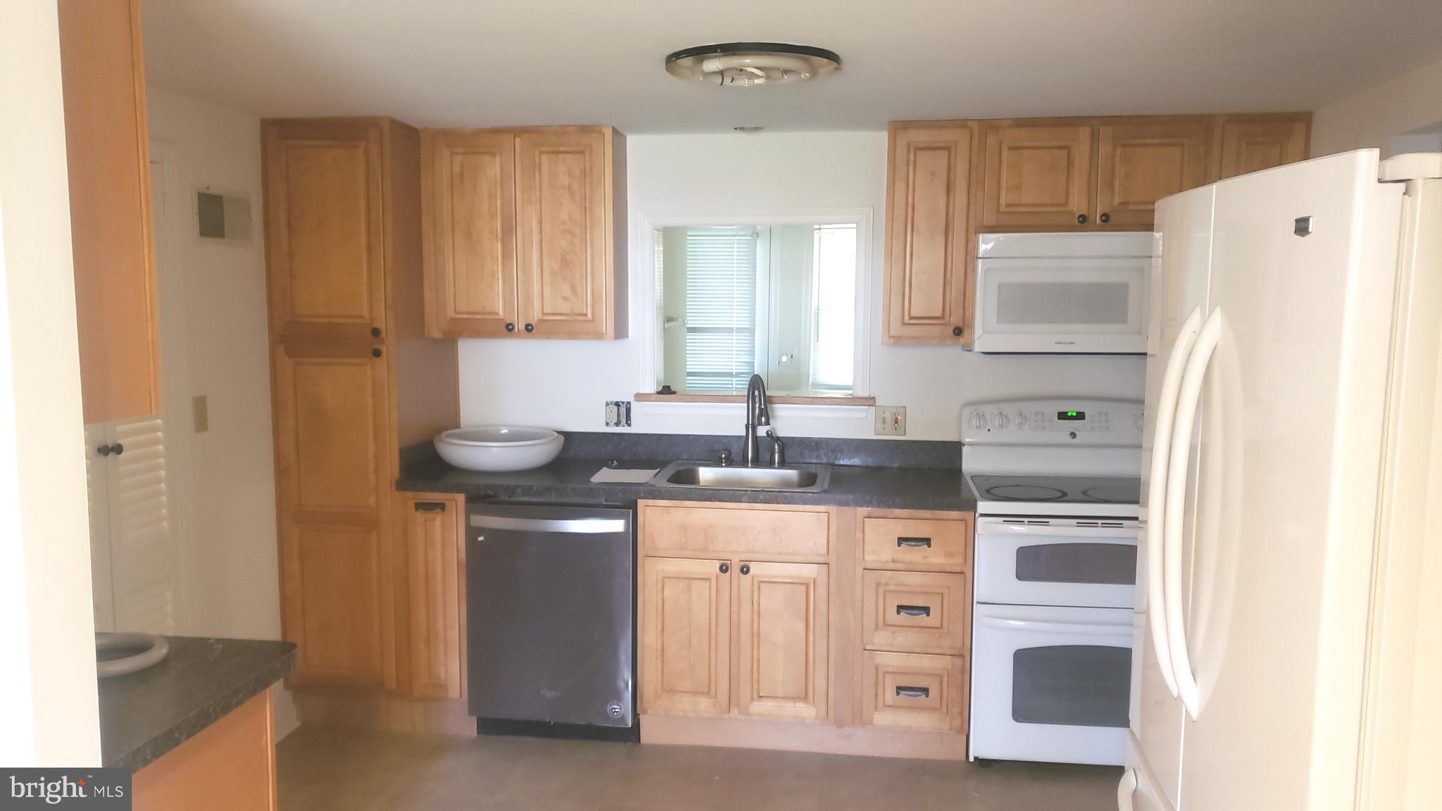 625 Southwood Road Hockessin, DE 19707 - Photo 6 of 16 a kitchen with stainless steel appliances granite countertop a sink stove and refrigerator