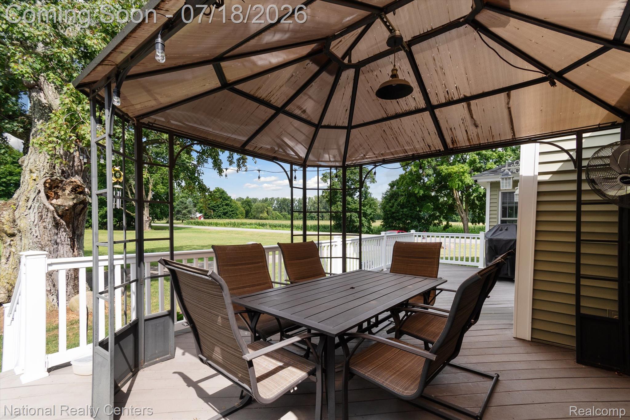 9589 Clinton Macon Road Tecumseh, MI 49286 - Photo 34 of 48 Expansive outdoor deck featuring a gazebo structure, composite decking, white railing, and exterior wall siding