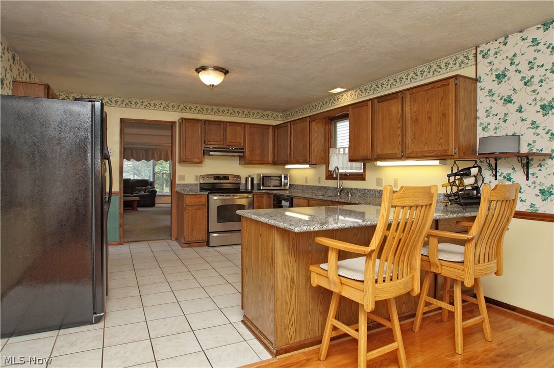 1273 Ford Road Lyndhurst, OH 44124 - Photo 10 of 32 Stainless steel gas stove and microwave plus dishwasher stay with the home.