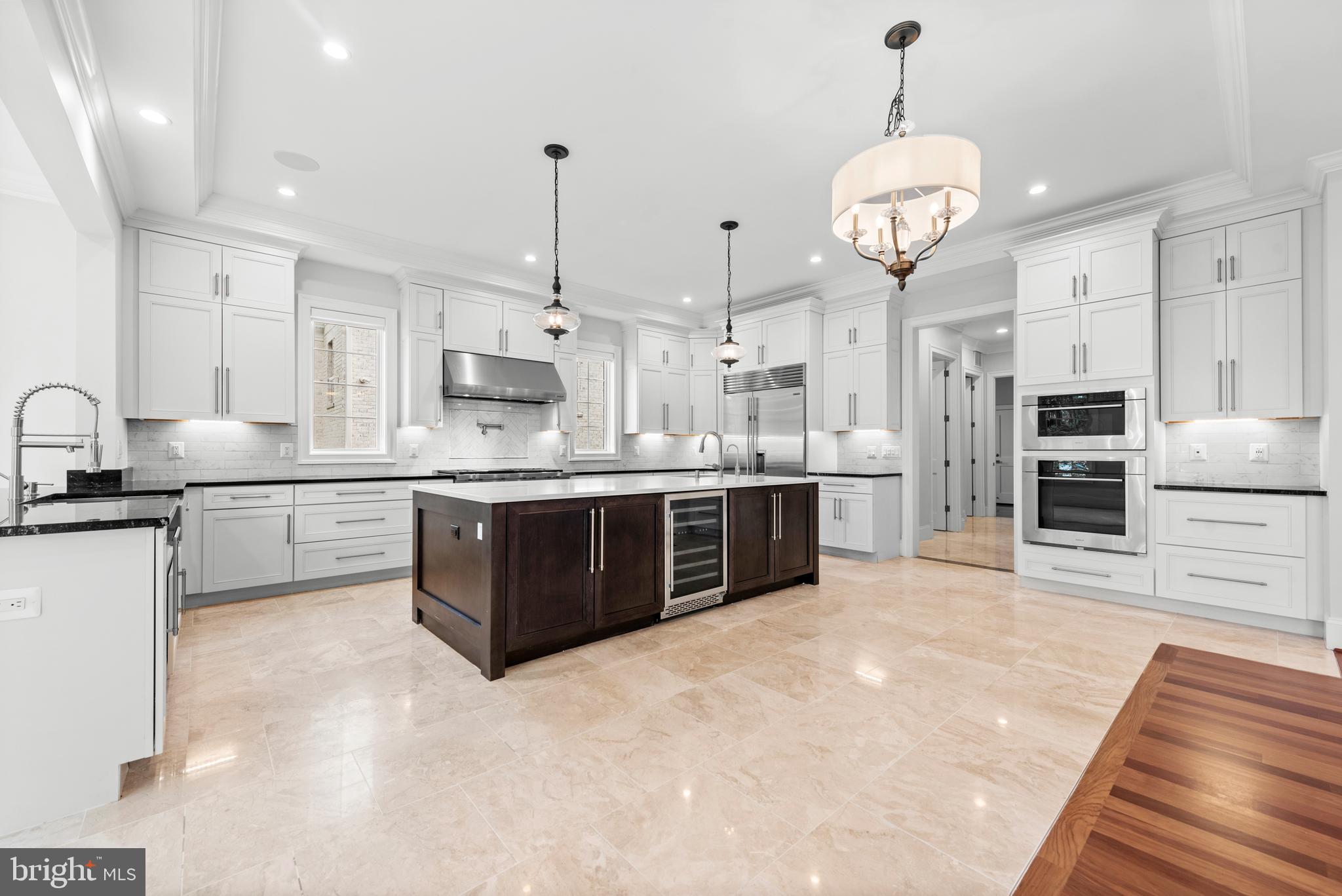 7003 Churchill Road McLean, VA 22101 - Photo 20 of 76 a large kitchen with stainless steel appliances kitchen island granite countertop a sink a stove and a refrigerator