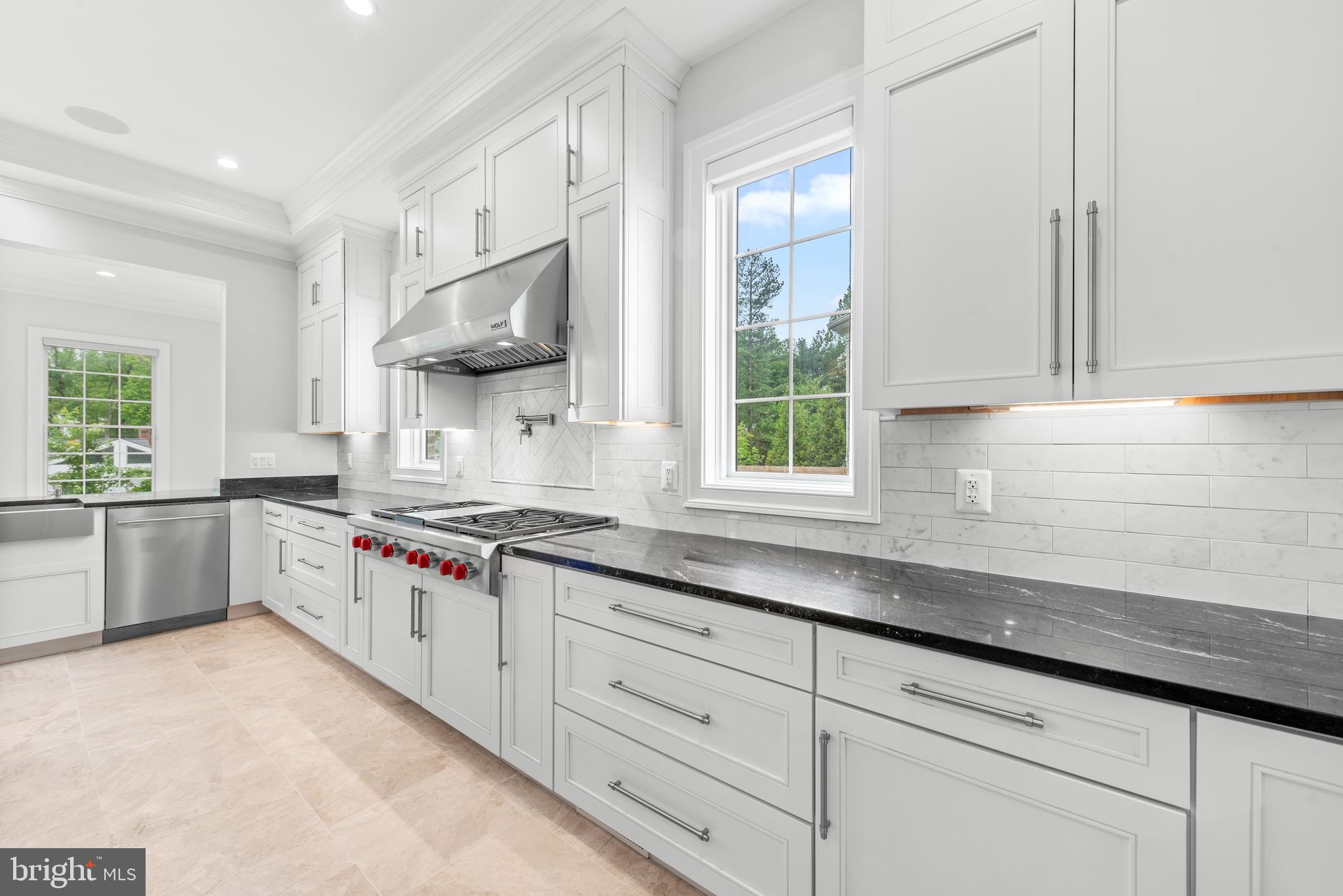 7003 Churchill Road McLean, VA 22101 - Photo 24 of 76 a kitchen with stainless steel appliances granite countertop a sink a stove and a window