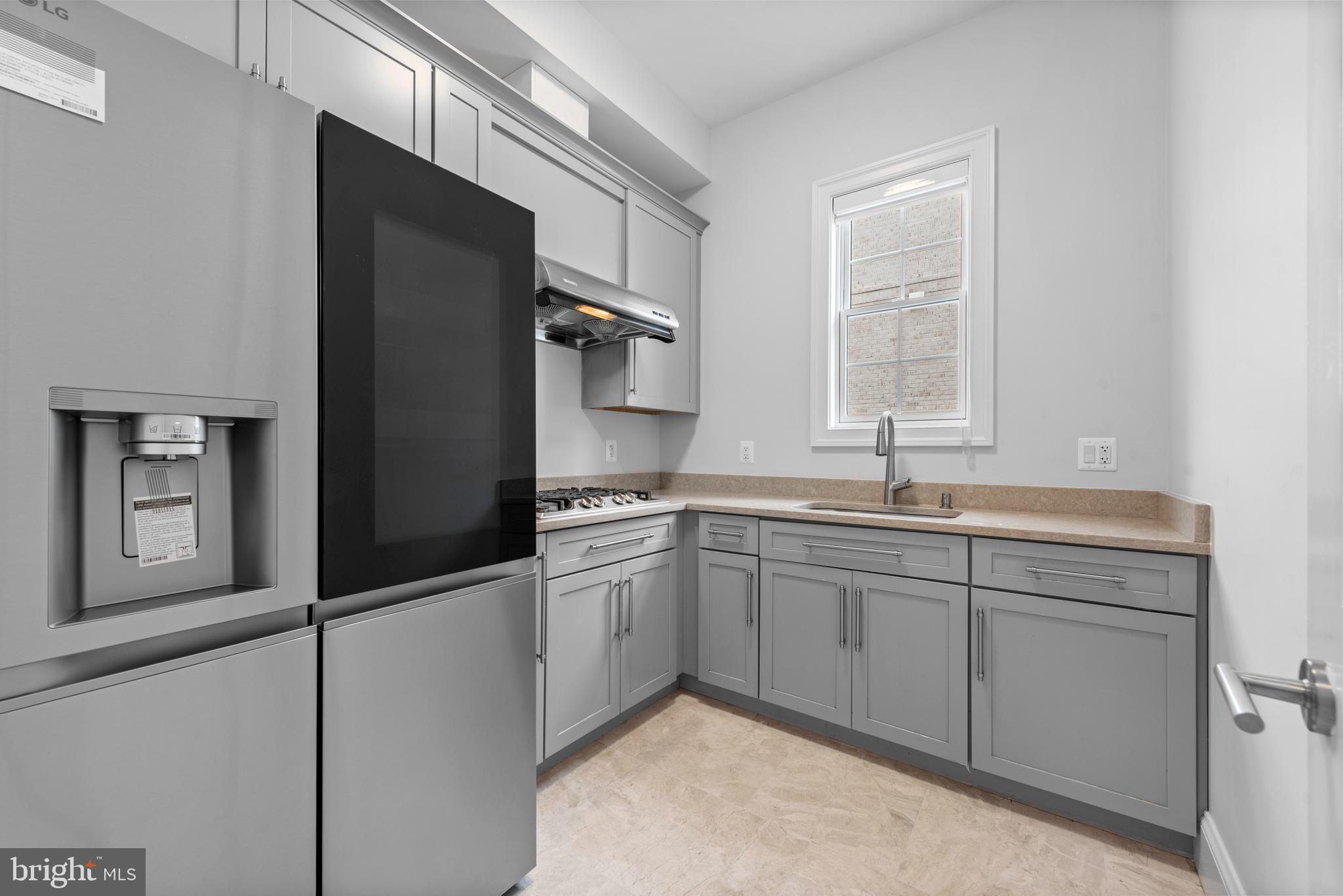7003 Churchill Road McLean, VA 22101 - Photo 29 of 76 a kitchen with stainless steel appliances granite countertop a sink and a refrigerator