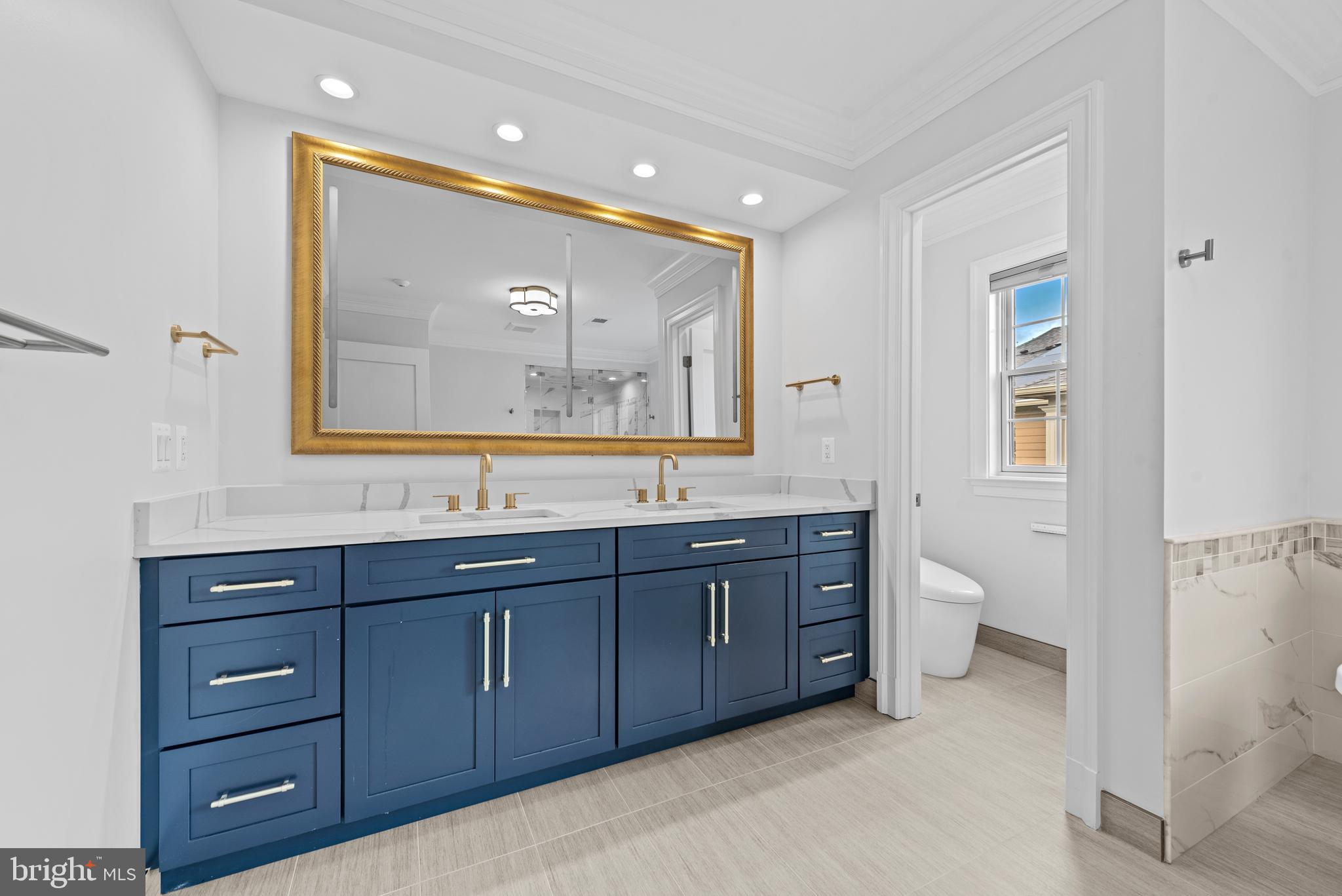 7003 Churchill Road McLean, VA 22101 - Photo 42 of 76 a spacious bathroom with a double vanity sink and a mirror