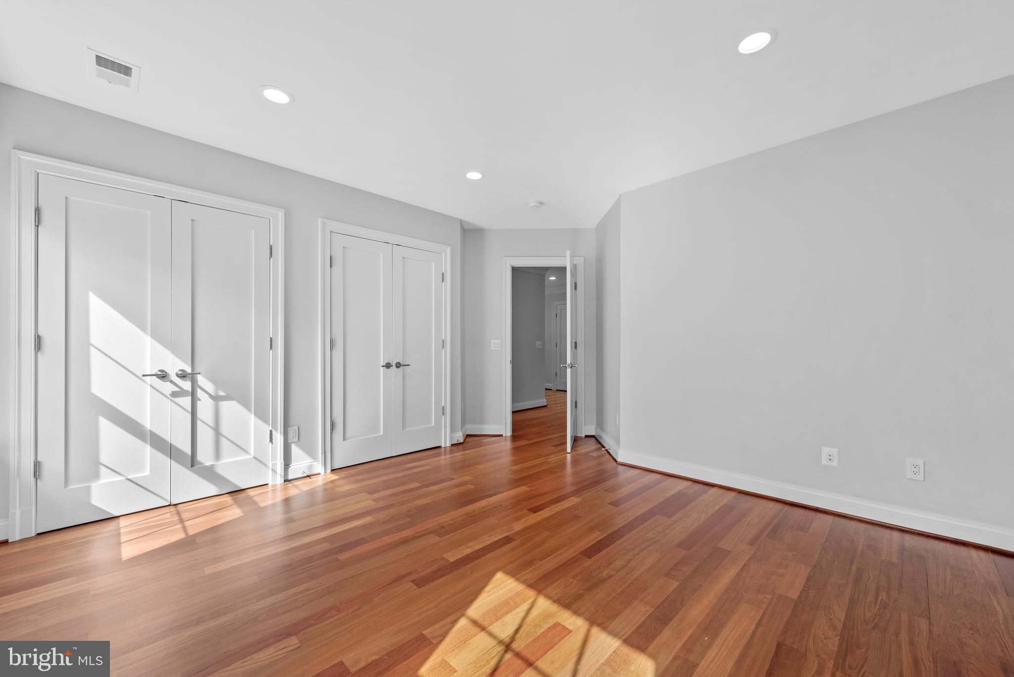 7003 Churchill Road McLean, VA 22101 - Photo 52 of 76 a view of an empty room with wooden floor