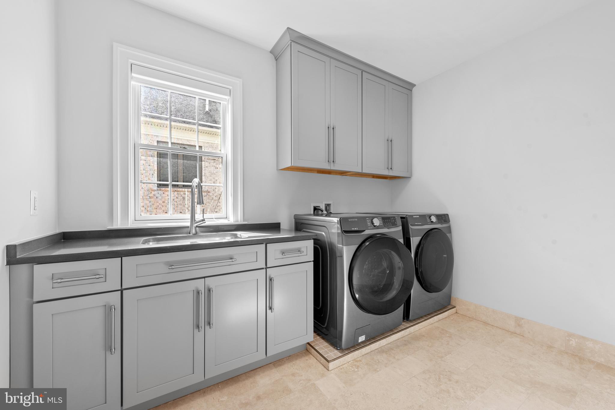 7003 Churchill Road McLean, VA 22101 - Photo 59 of 76 a utility room with sink dryer and washer