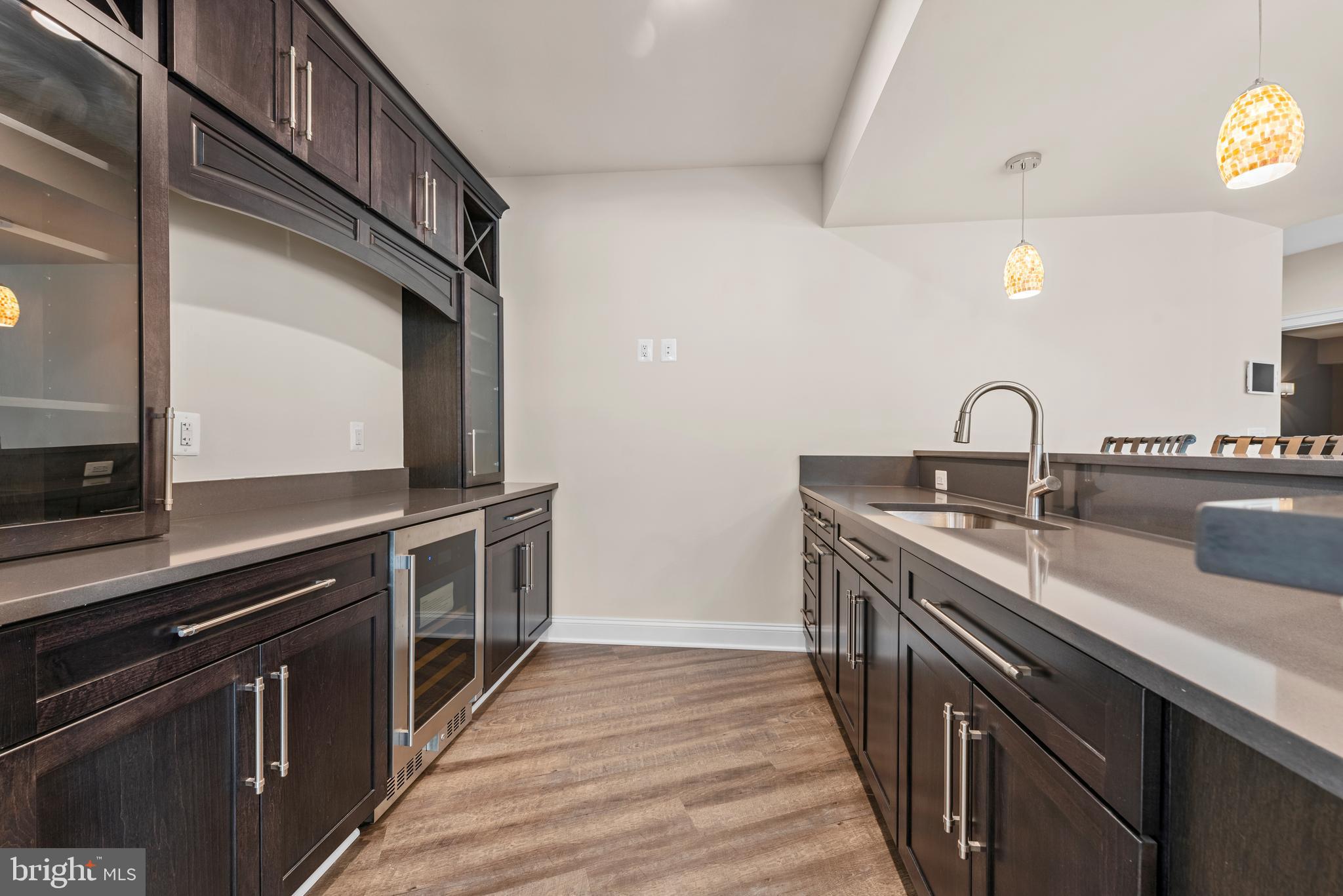 7003 Churchill Road McLean, VA 22101 - Photo 65 of 76 a kitchen with stainless steel appliances granite countertop a sink and a stove top oven