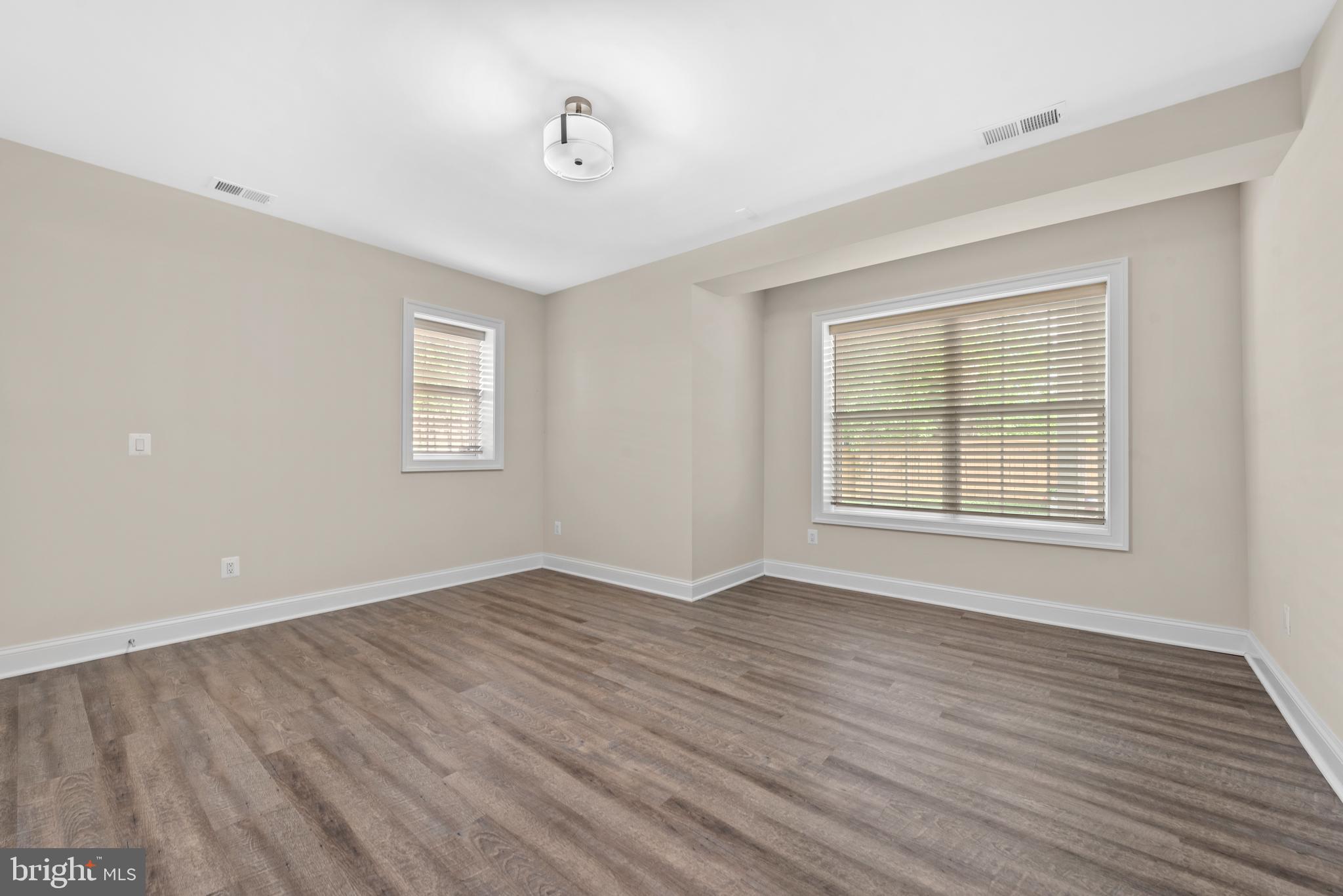 7003 Churchill Road McLean, VA 22101 - Photo 67 of 76 a view of an empty room with wooden floor and a window