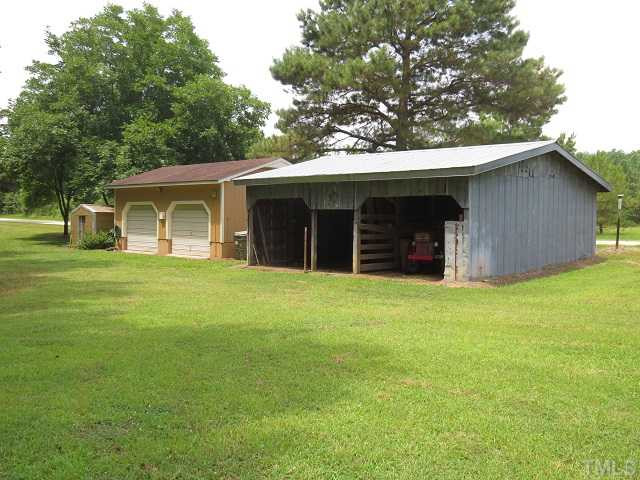 571 Lee Road, Unit B Clayton, NC 27520 - Photo 5 of 25 Green house, double car garage with electric & water, two stall shed for horses, live stock, or tractor and equipment.
