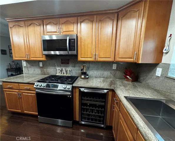 a kitchen with stainless steel appliances granite countertop a stove and a microwave