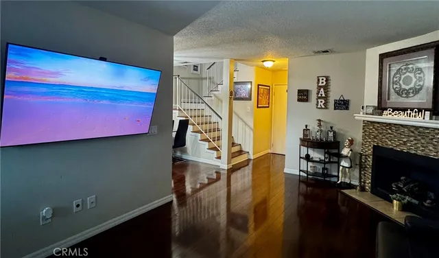 a view of a livingroom with furniture staircase and a fireplace