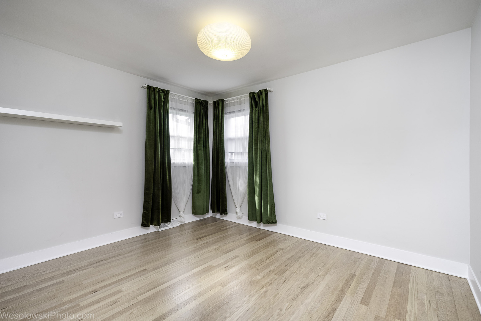 708 North Russel Street Mount Prospect, IL 60056 - Photo 13 of 30 an empty room with wooden floor and windows