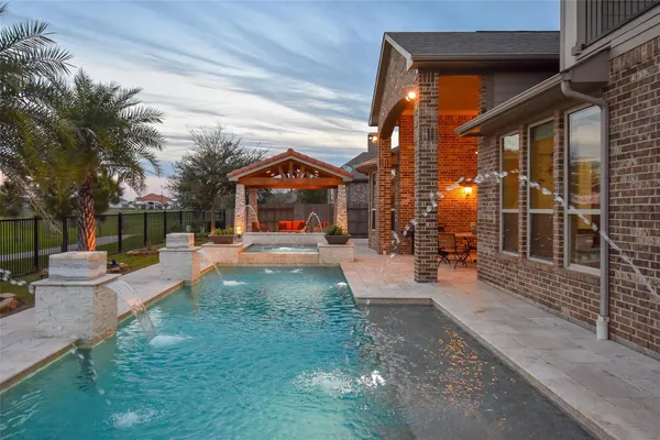 a view of a house with backyard porch and sitting area