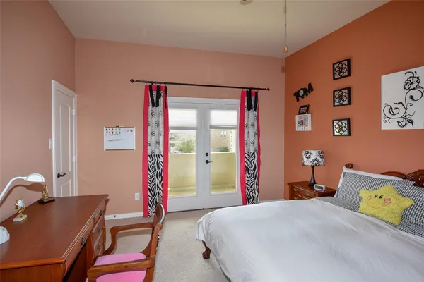 a bedroom with a bed and a desk