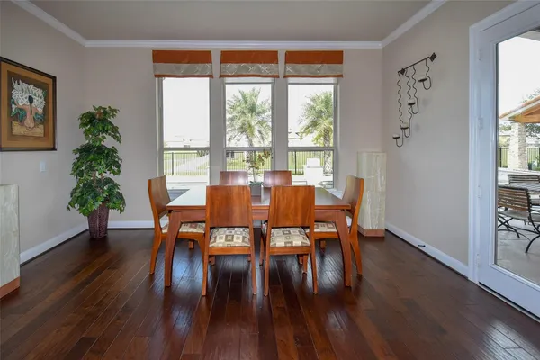 a dining room with furniture window and wooden floor
