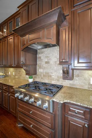a kitchen with granite countertop a stove and a sink