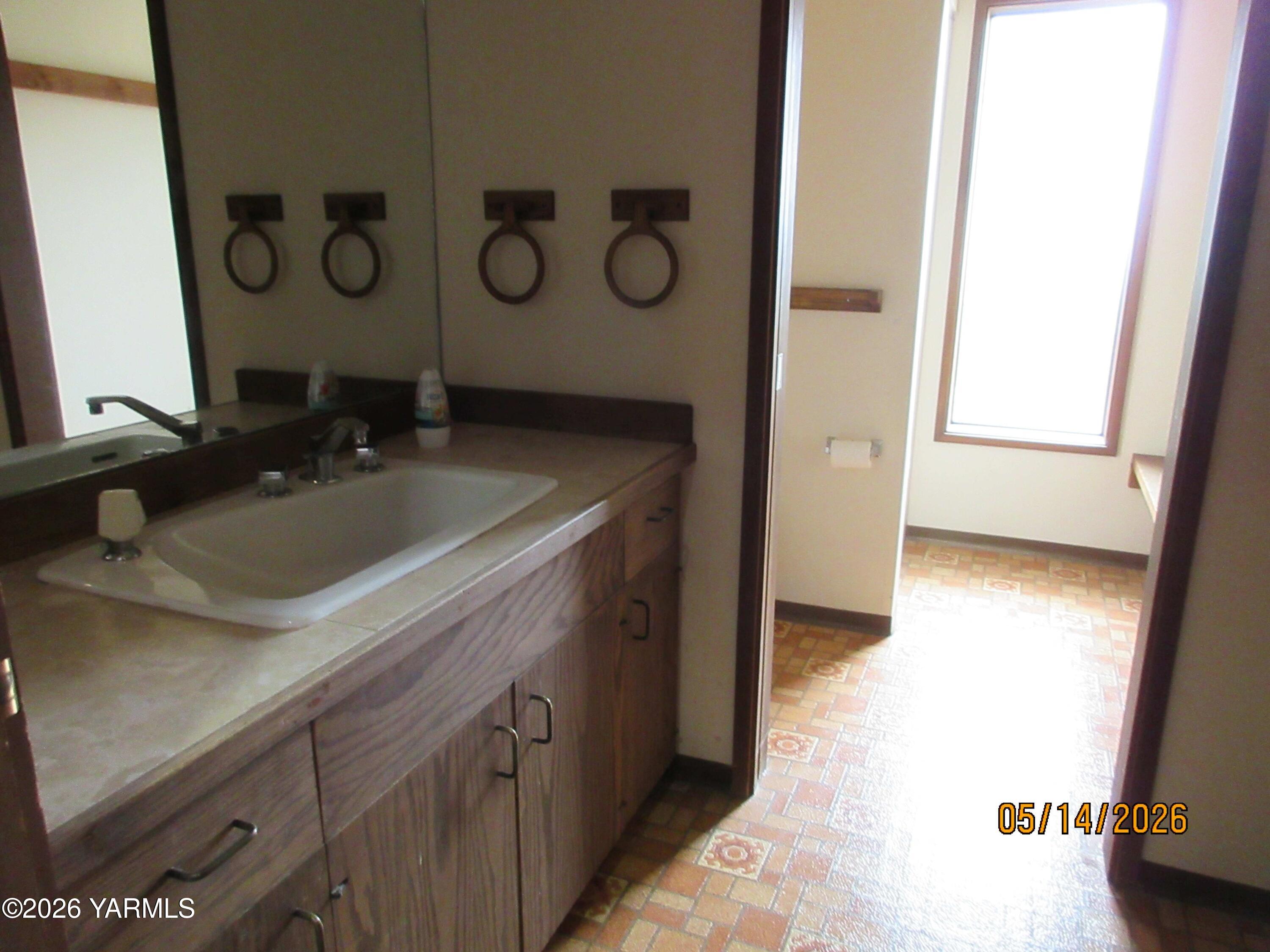 1303 Nightingale Road Wapato, WA 98951 - Photo 18 of 26 a bathroom with a sink and a mirror