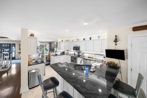 a living room with dining room and a flat screen tv