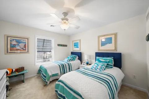 a bedroom with two beds and a chandelier