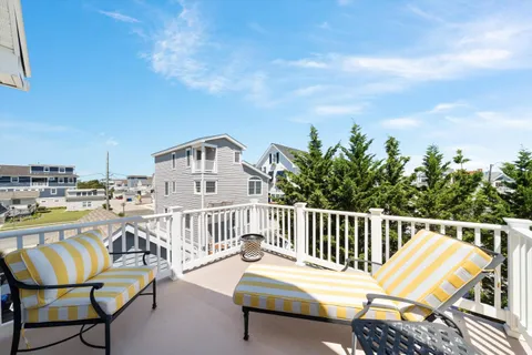 a balcony with a table and chairs