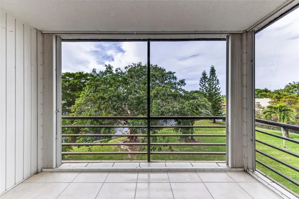 a view of a room with wooden floor and windows