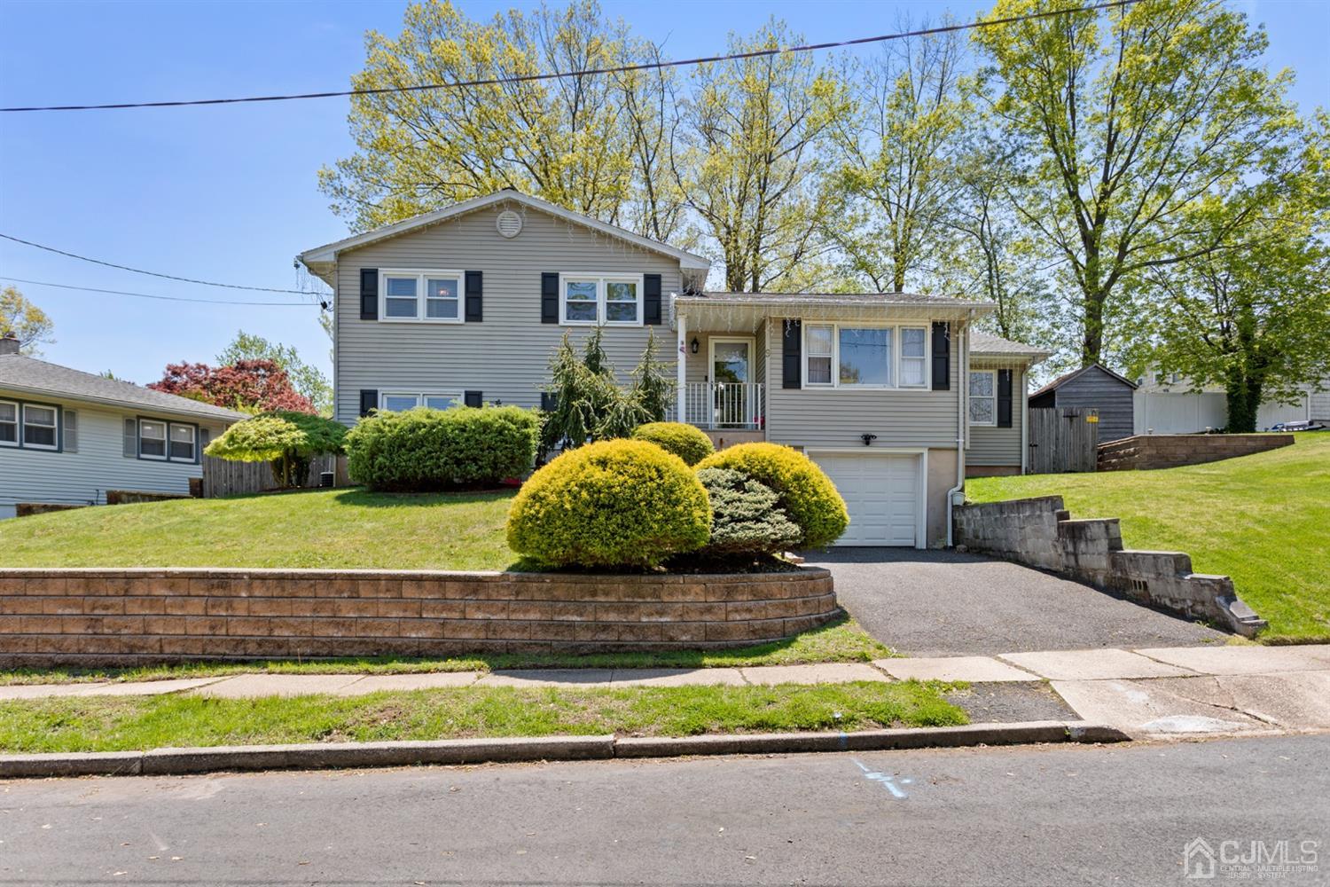 9 Larchmont Road Edison, NJ 08837 - Photo 2 of 31 a front view of a house with a yard and garage