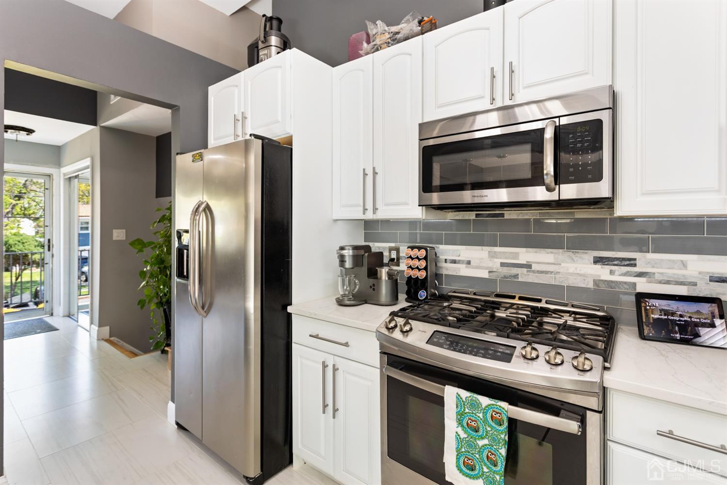 9 Larchmont Road Edison, NJ 08837 - Photo 11 of 31 a kitchen with stainless steel appliances a stove a microwave and a refrigerator