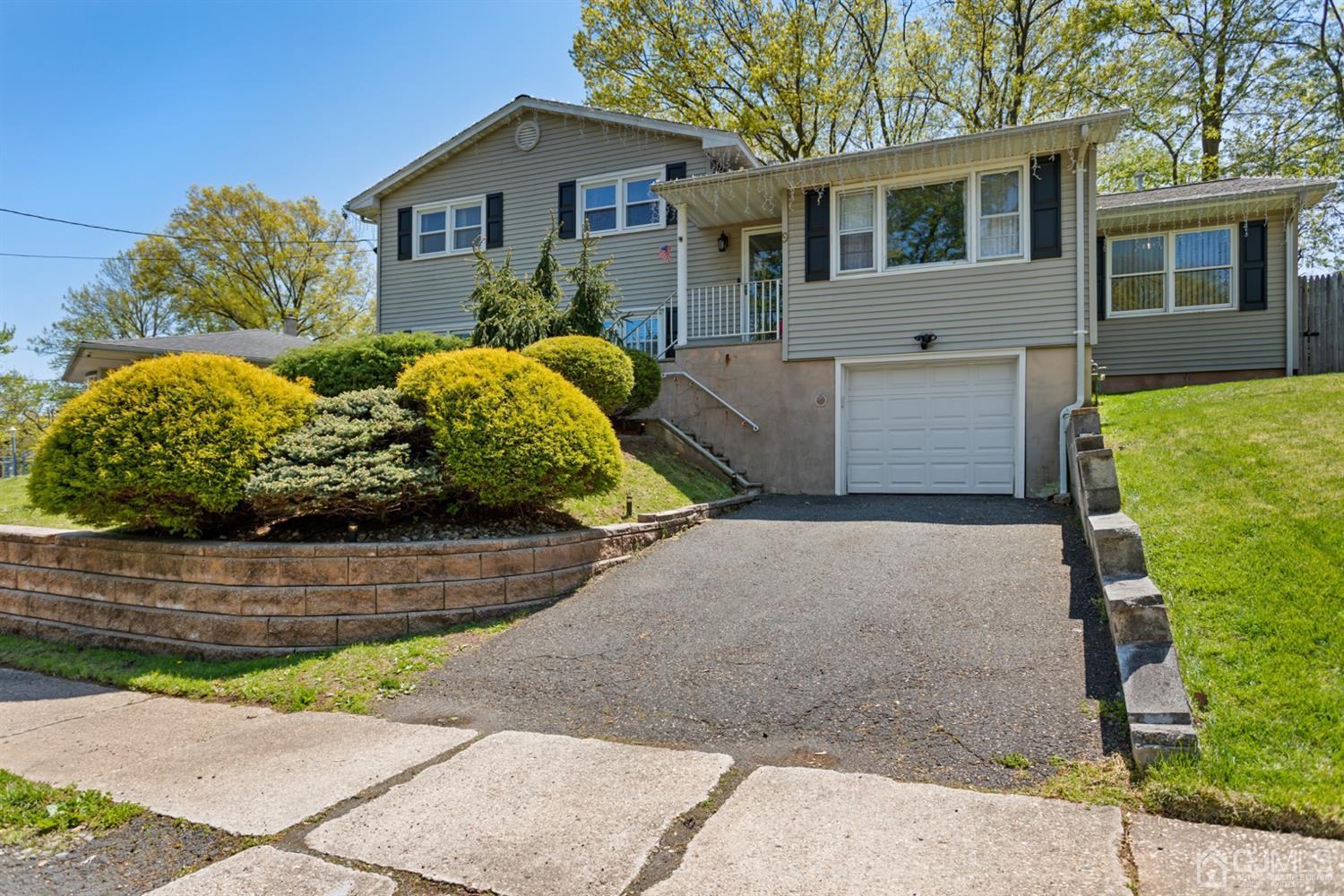 9 Larchmont Road Edison, NJ 08837 - Photo 3 of 31 a front view of a house with a yard and garage