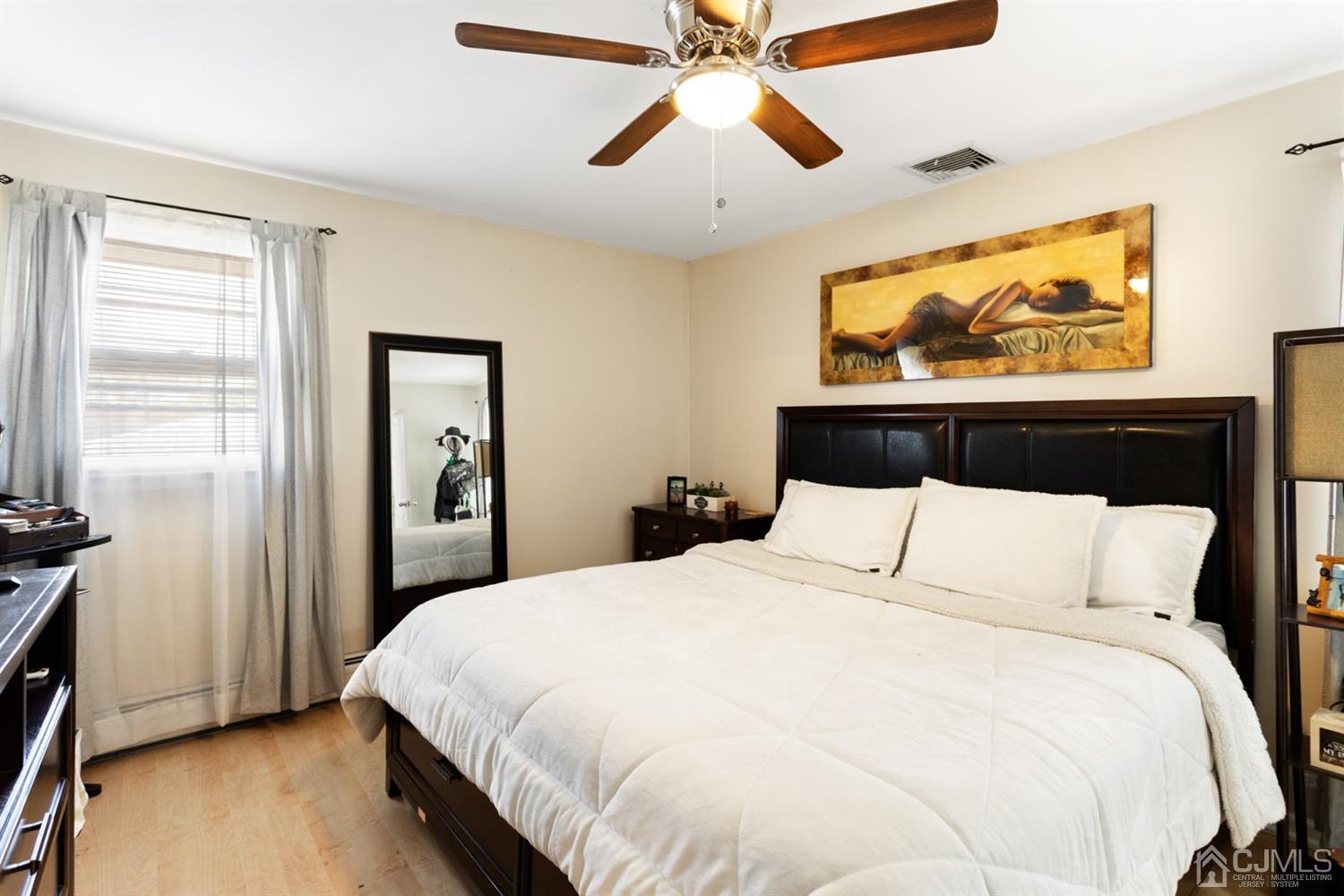 9 Larchmont Road Edison, NJ 08837 - Photo 21 of 31 a bedroom with a bed and wooden floor