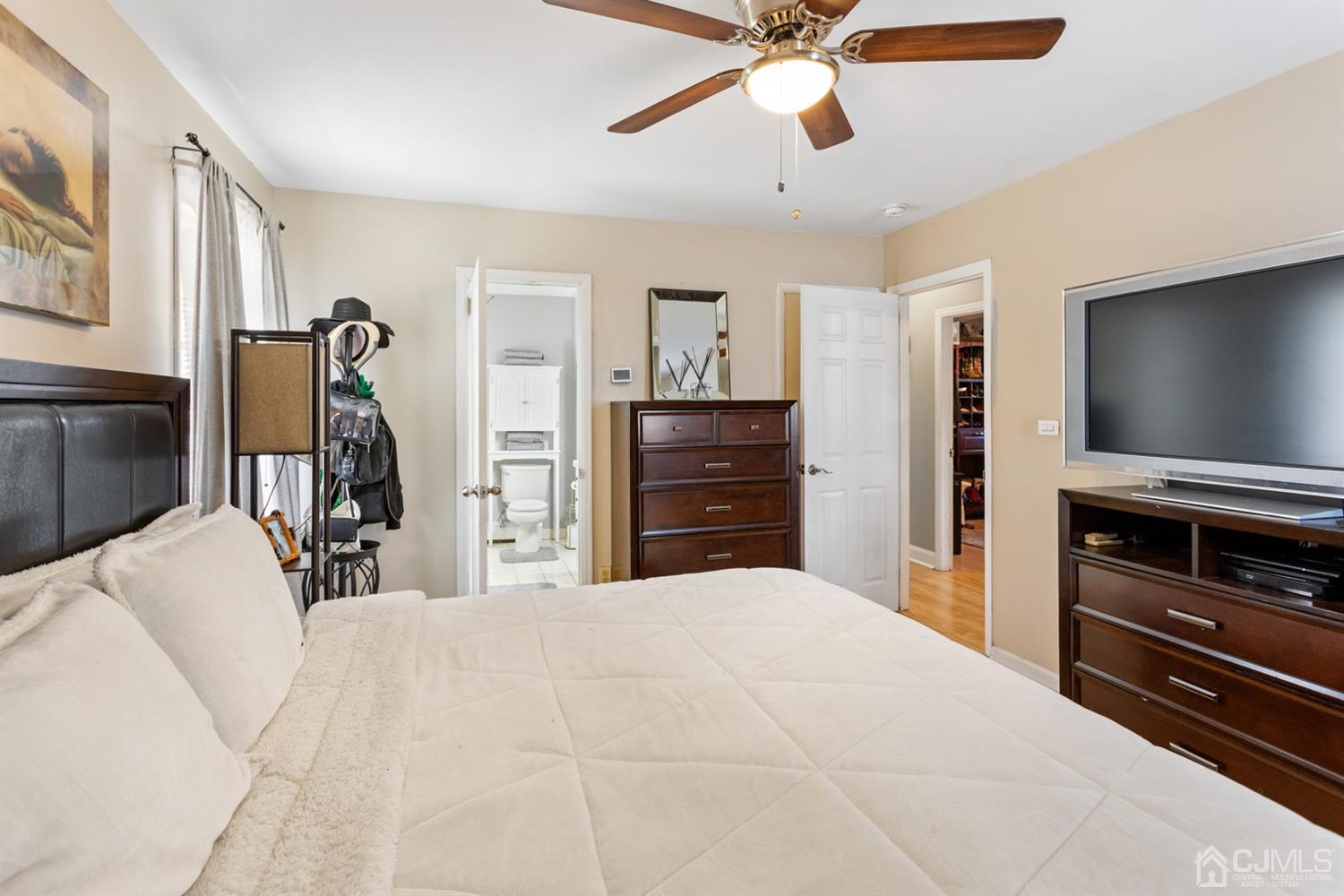 9 Larchmont Road Edison, NJ 08837 - Photo 22 of 31 a bedroom with a bed and a flat tv screen on dresser