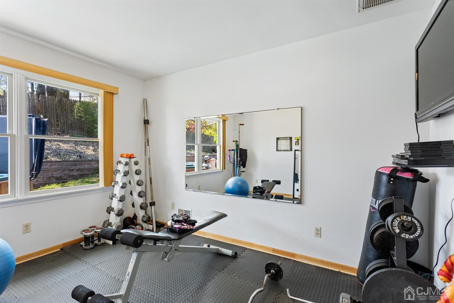 9 Larchmont Road Edison, NJ 08837 - Photo 28 of 31 a room with gym equipment and a large window