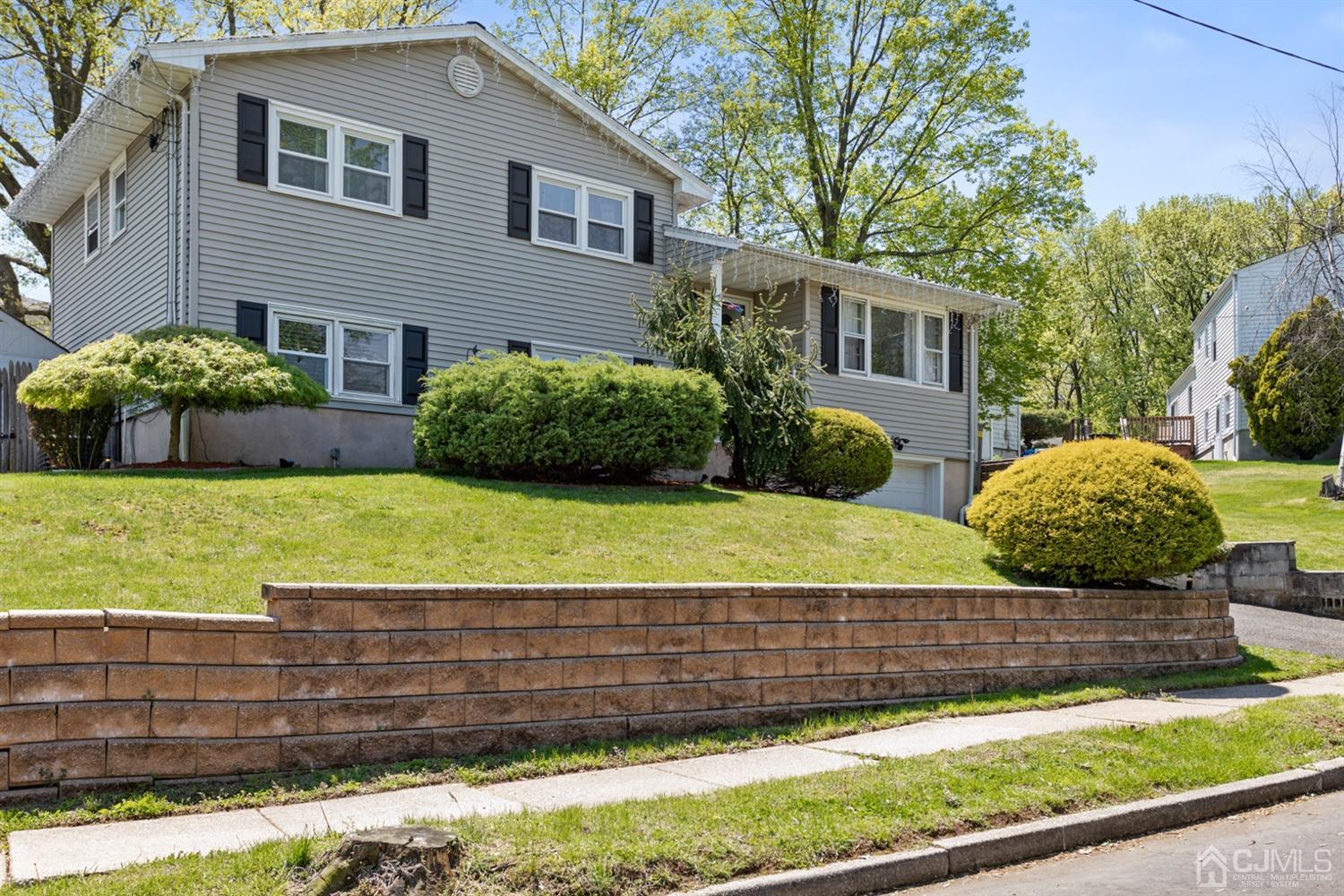 9 Larchmont Road Edison, NJ 08837 - Photo 4 of 31 a view of a house with a yard and large trees