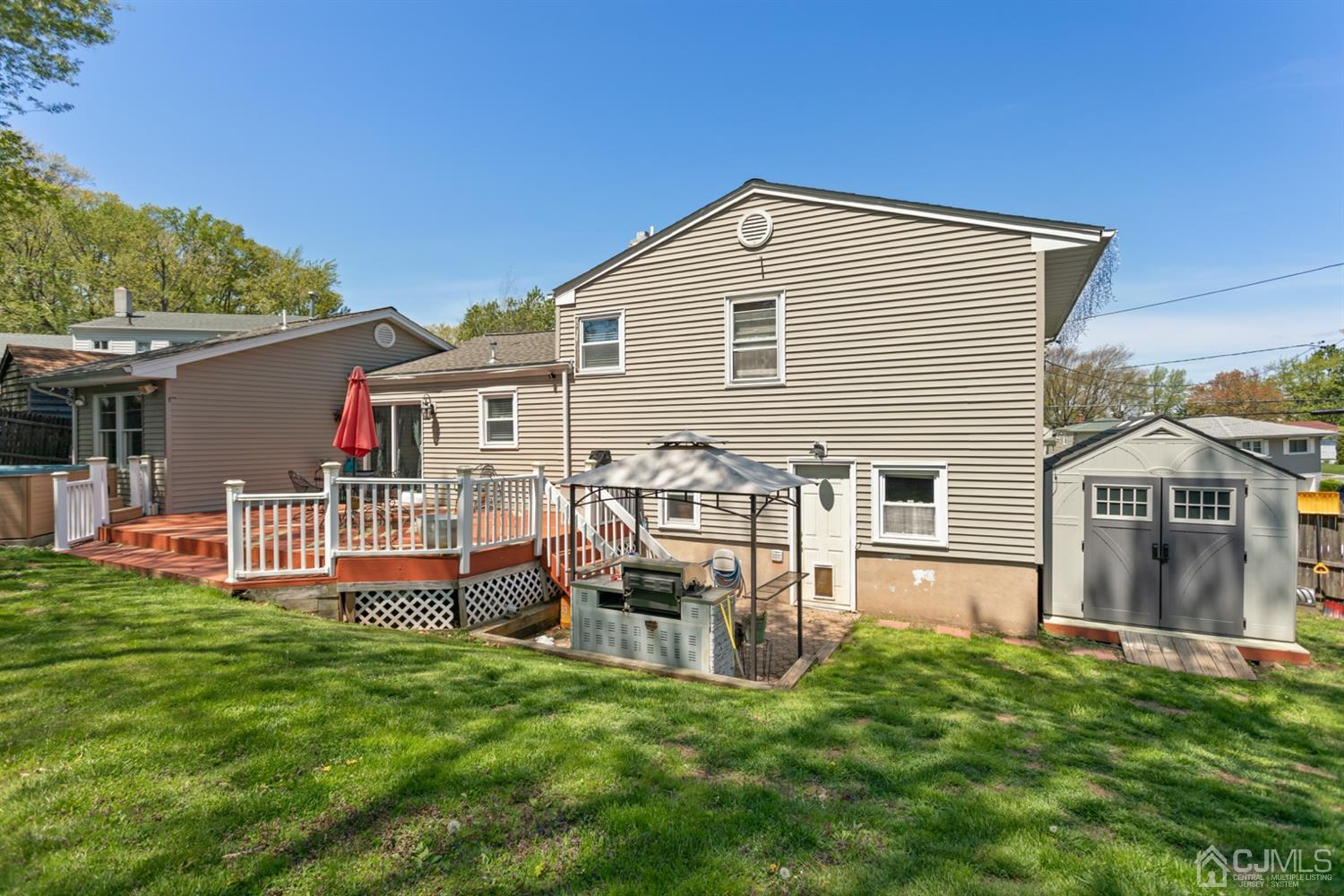 9 Larchmont Road Edison, NJ 08837 - Photo 31 of 31 a front view of a house with a yard table and chairs