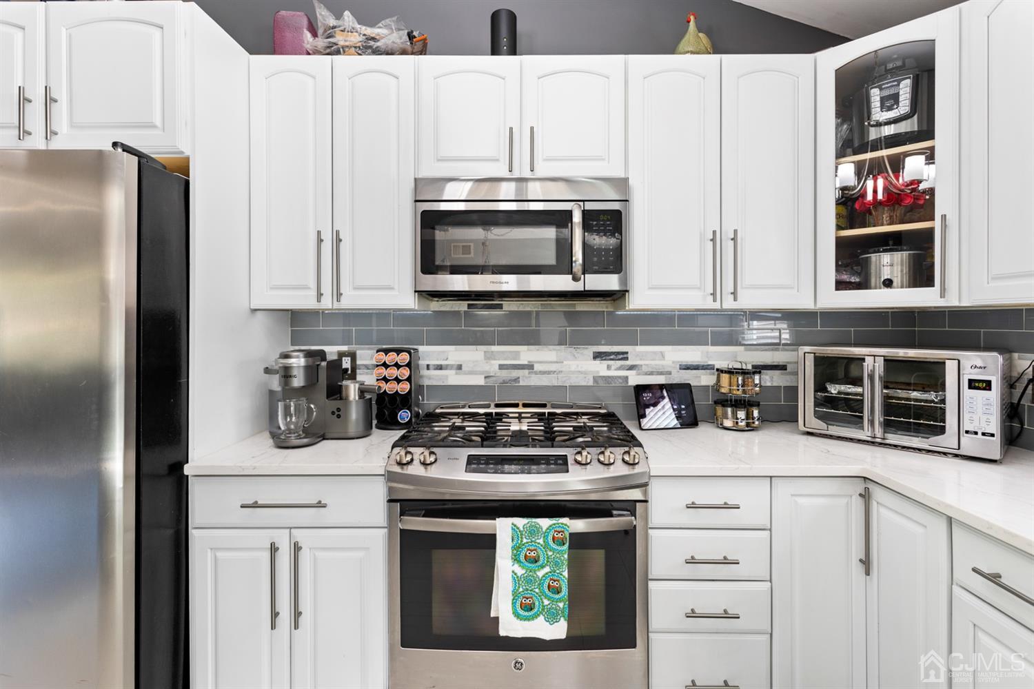 9 Larchmont Road Edison, NJ 08837 - Photo 10 of 31 a kitchen with stainless steel appliances granite countertop a stove a microwave and a refrigerator
