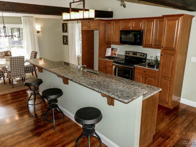 3085 Bursonville Road Riegelsville, PA 18077 - Photo 16 of 31 a kitchen with stainless steel appliances granite countertop a sink a stove and a refrigerator