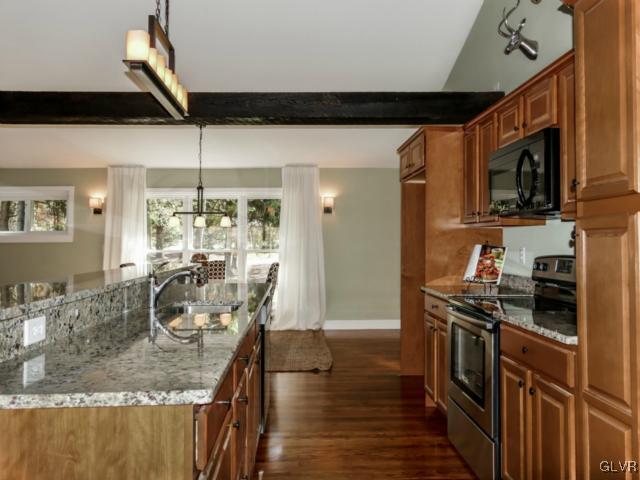 3085 Bursonville Road Riegelsville, PA 18077 - Photo 17 of 31 a kitchen with stainless steel appliances granite countertop a stove top oven a sink a counter space and cabinets