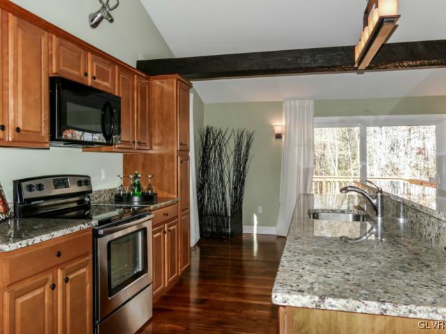 3085 Bursonville Road Riegelsville, PA 18077 - Photo 18 of 31 a kitchen with stainless steel appliances granite countertop a stove a sink and a microwave