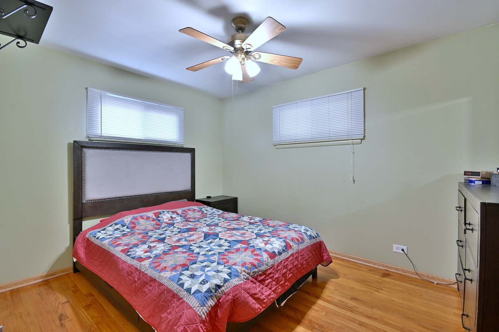 511 West Byron Avenue Addison, IL 60101 - Photo 13 of 31 a bedroom with a large bed and a chandelier