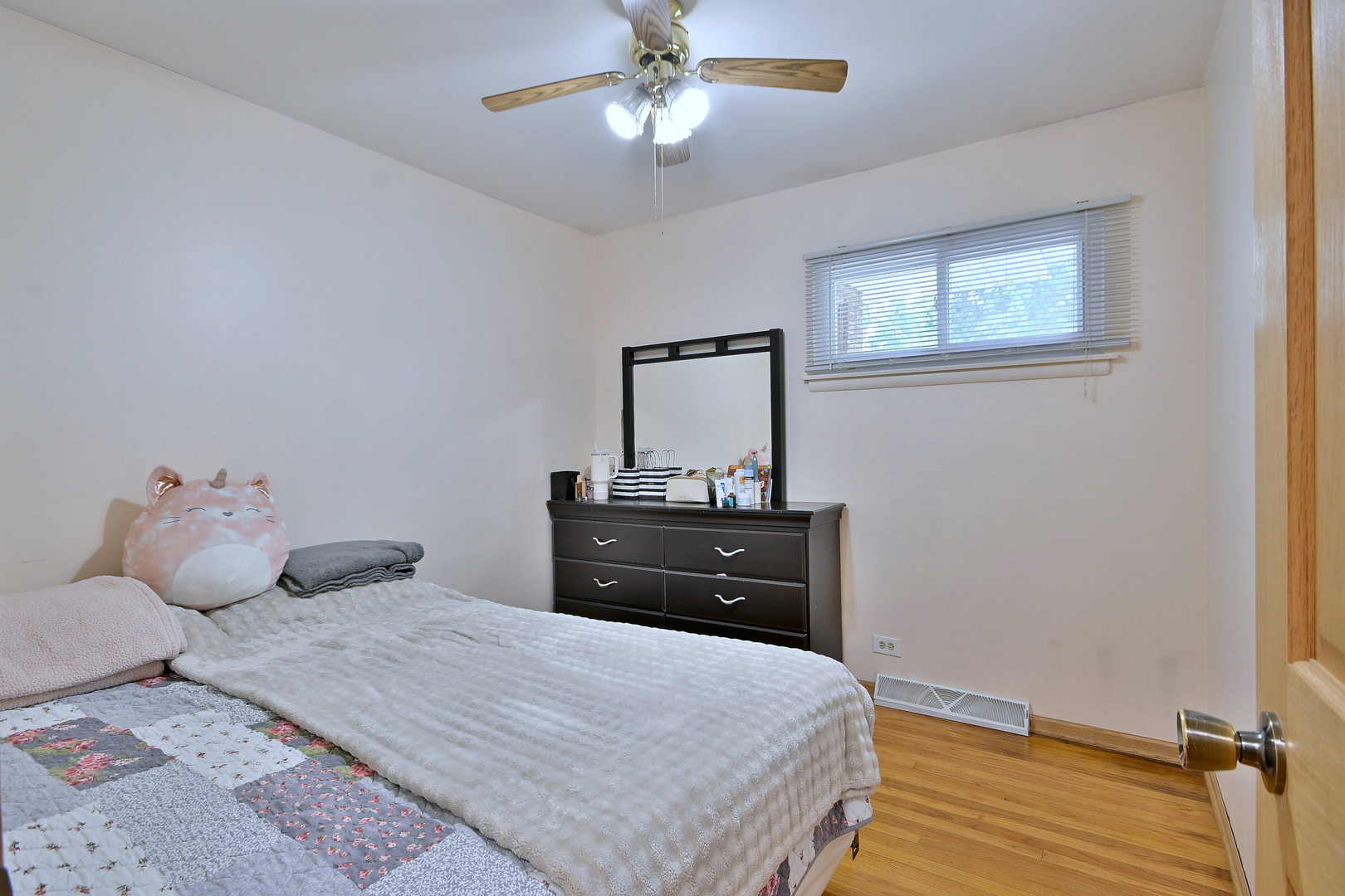 511 West Byron Avenue Addison, IL 60101 - Photo 15 of 31 a bedroom with a bed and a chandelier