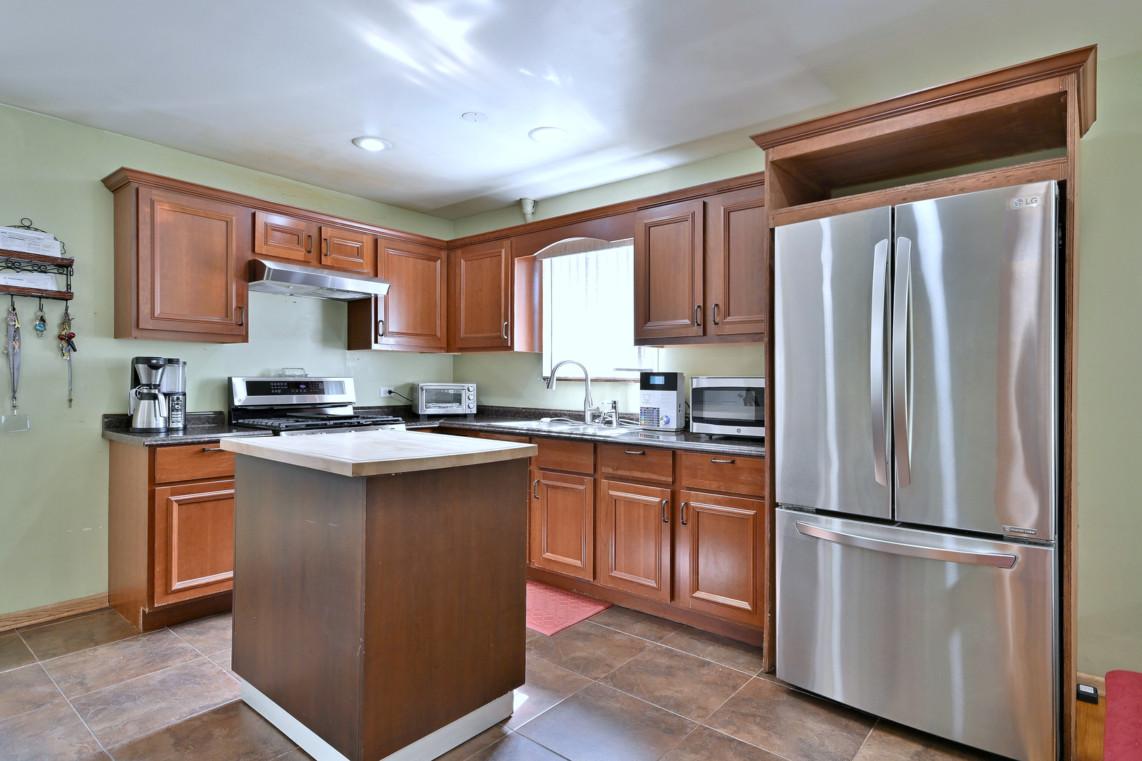 511 West Byron Avenue Addison, IL 60101 - Photo 8 of 31 a kitchen with stainless steel appliances granite countertop a refrigerator sink and cabinets