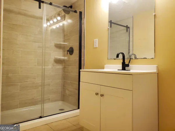 a bathroom with a shower and a sink