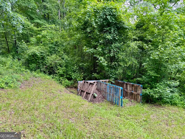 a backyard of a house with yard and trampoline