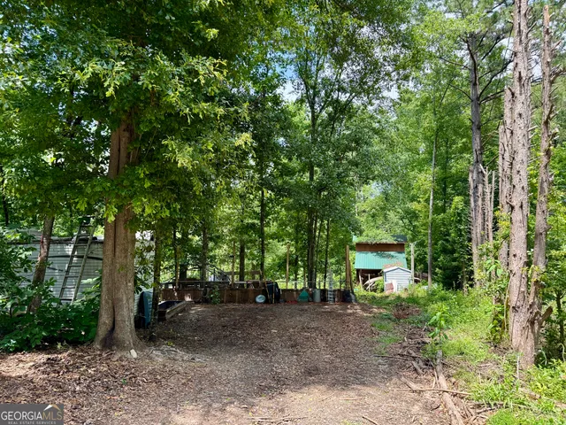a view of a house with large trees