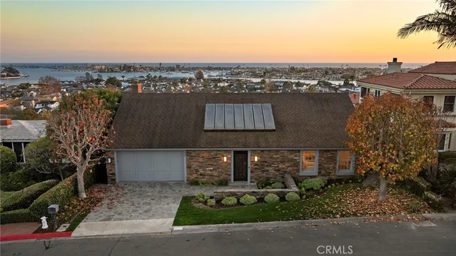 a backyard of a house with table and chairs under an umbrella