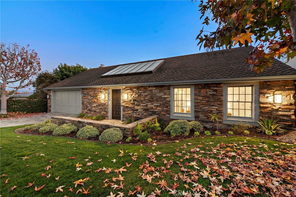 521 Kings Road Newport Beach, CA 92663 - Photo 12 of 48 a backyard of a house with table and chairs under an umbrella