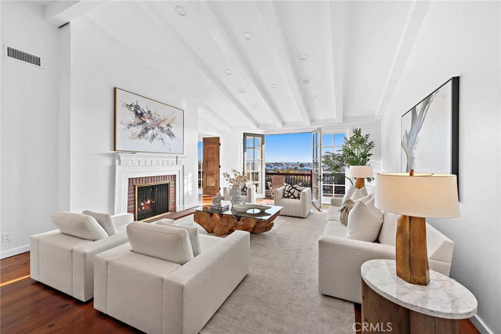 521 Kings Road Newport Beach, CA 92663 - Photo 14 of 48 a living room with furniture a fireplace and a table
