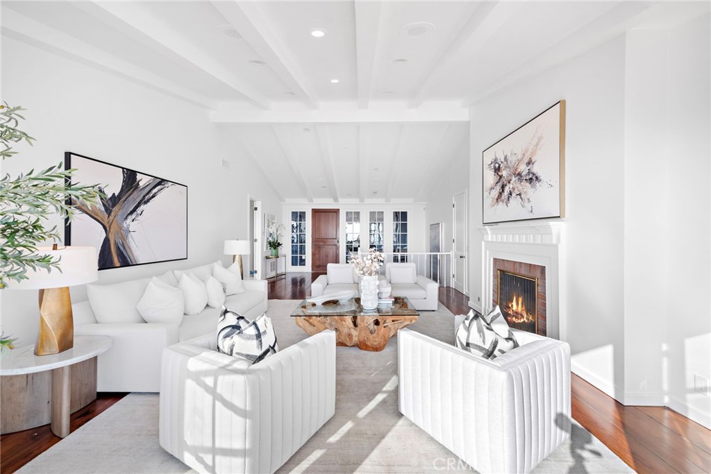 521 Kings Road Newport Beach, CA 92663 - Photo 17 of 48 a living room with furniture a fireplace and a flat screen tv