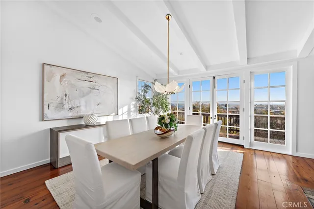 a view of a dining room with furniture wooden floor and a fireplace