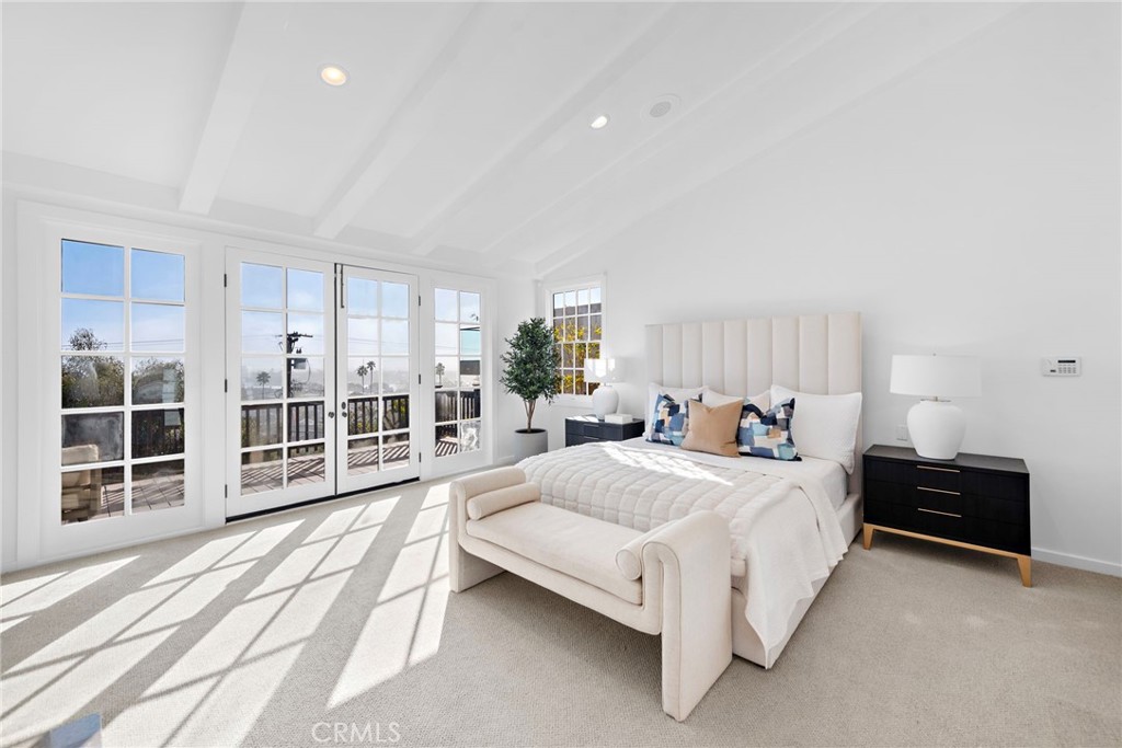 521 Kings Road Newport Beach, CA 92663 - Photo 24 of 48 a spacious bedroom with a bed and a large window
